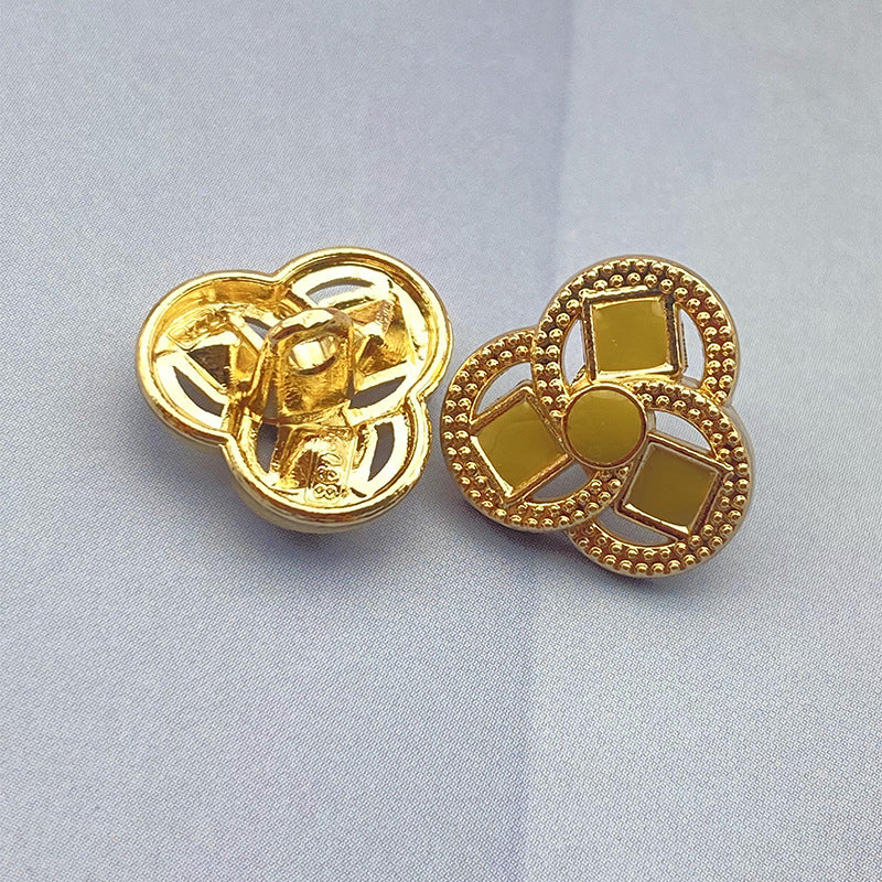 Clover-shaped flower metal shank shirt button, yellow inset squares, gold-tone finish