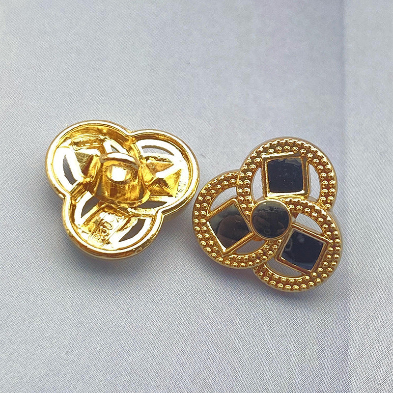Clover-shaped flower metal shank shirt button, black inset squares, gold-tone finish