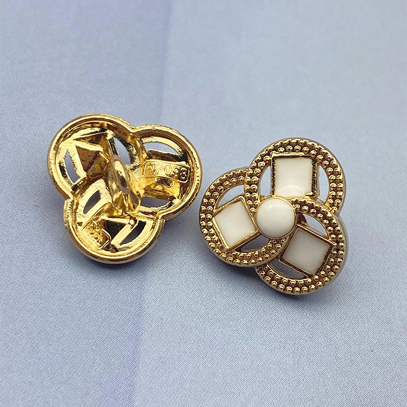 Clover-shaped flower metal shank shirt button, white inset squares, gold-tone finish