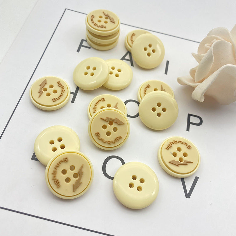 Round 4-hole resin buttons in cream with lightning graphic, assorted pack pieces