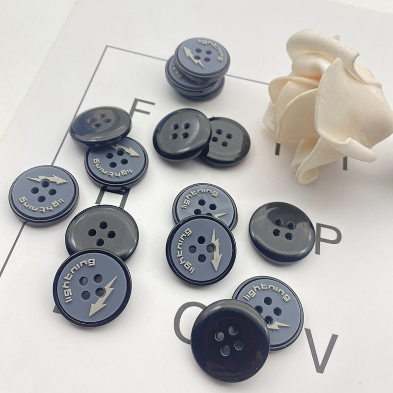 Round 4-hole dark navy resin buttons with lightning graphic, several sizes shown