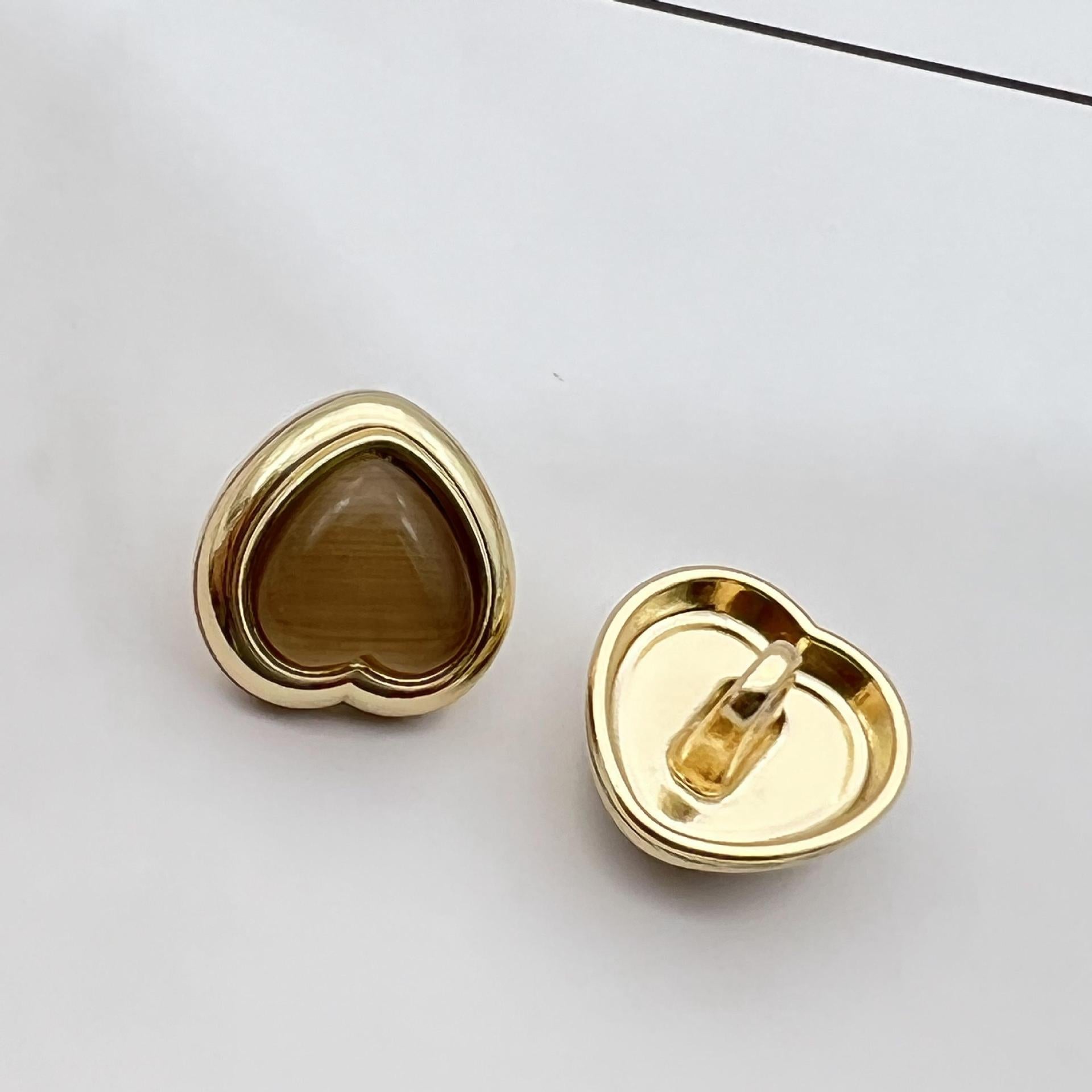 Heart-shaped pearlized resin button, brown center with gold metal shank and back