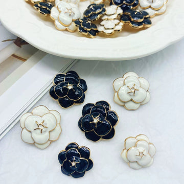 Camellia metal sweater buttons, black and white enamel with gold-tone shank, 5 shown