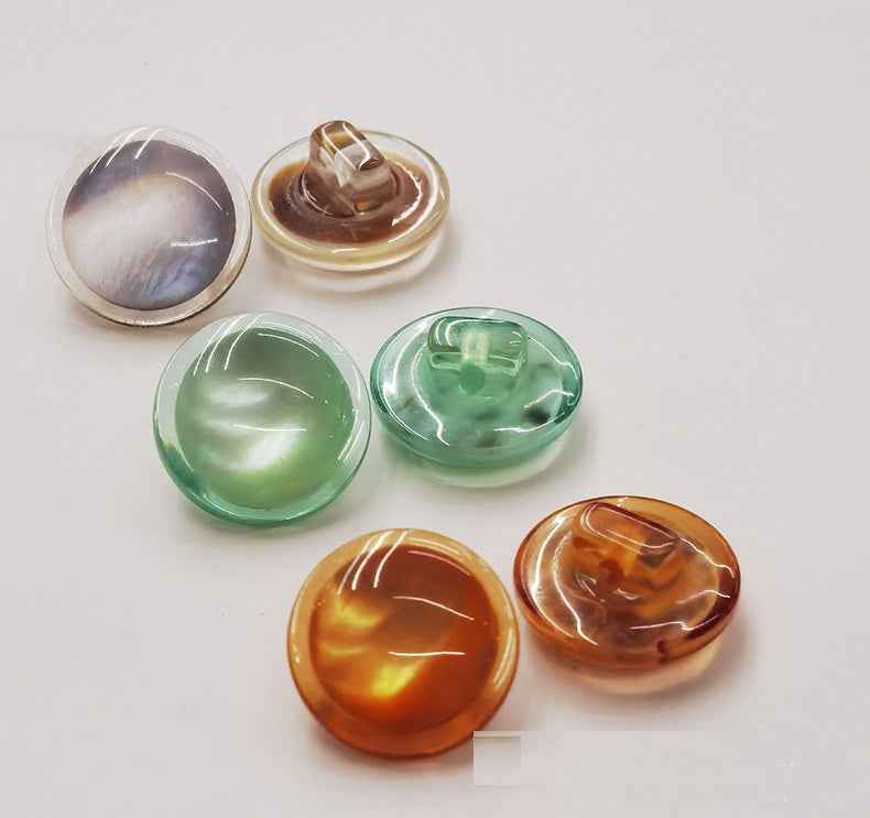Resin shank buttons set: clear, green, amber, and brownish amber domes