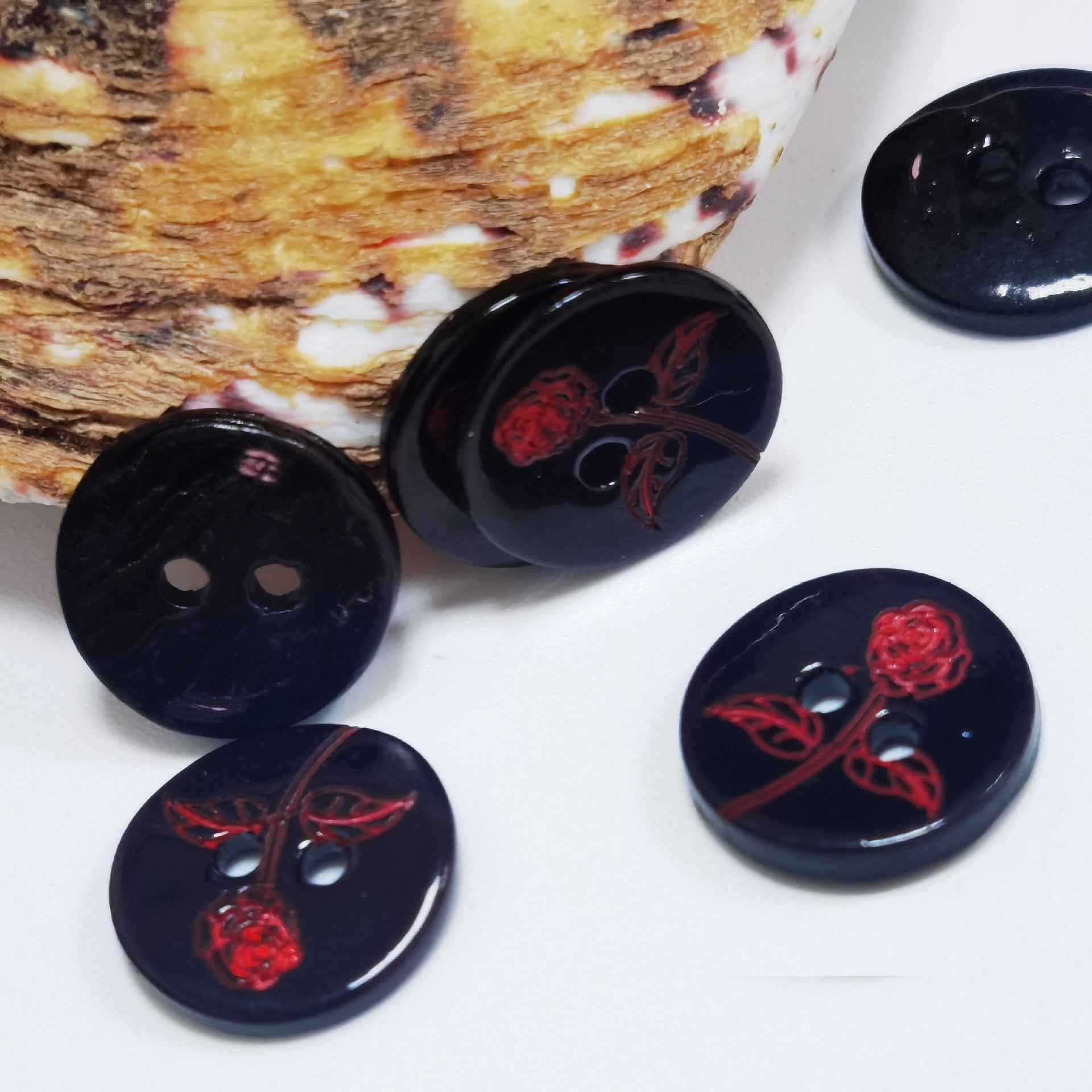Round glossy black buttons with red floral rose vine print, shell-look, mixed hole styles