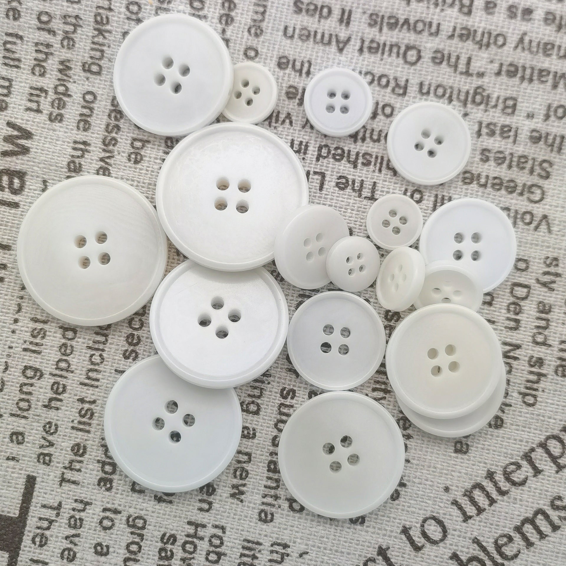 White knit buttons, 4-hole, assorted sizes