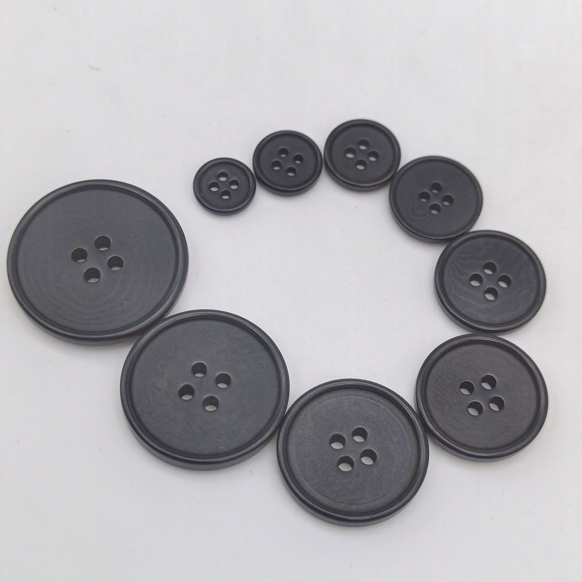 Black knit buttons, 4-hole, assorted sizes