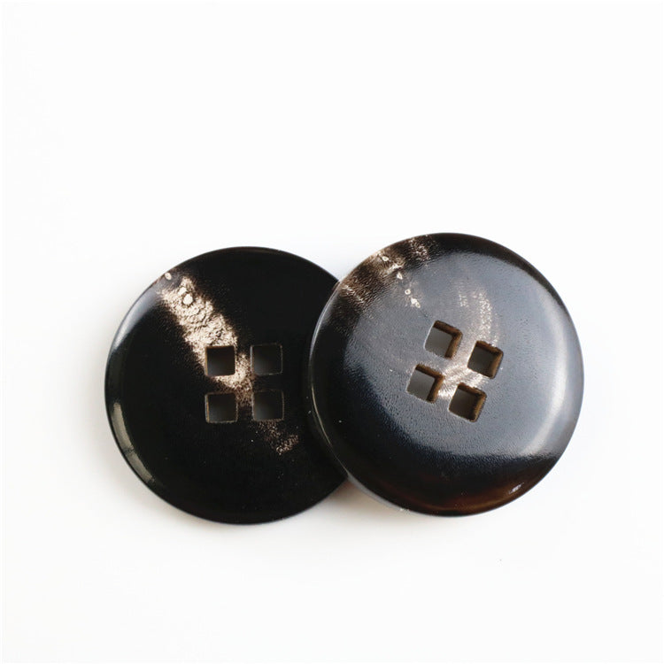 Round black buffalo horn buttons, four square holes, 2 shown from front