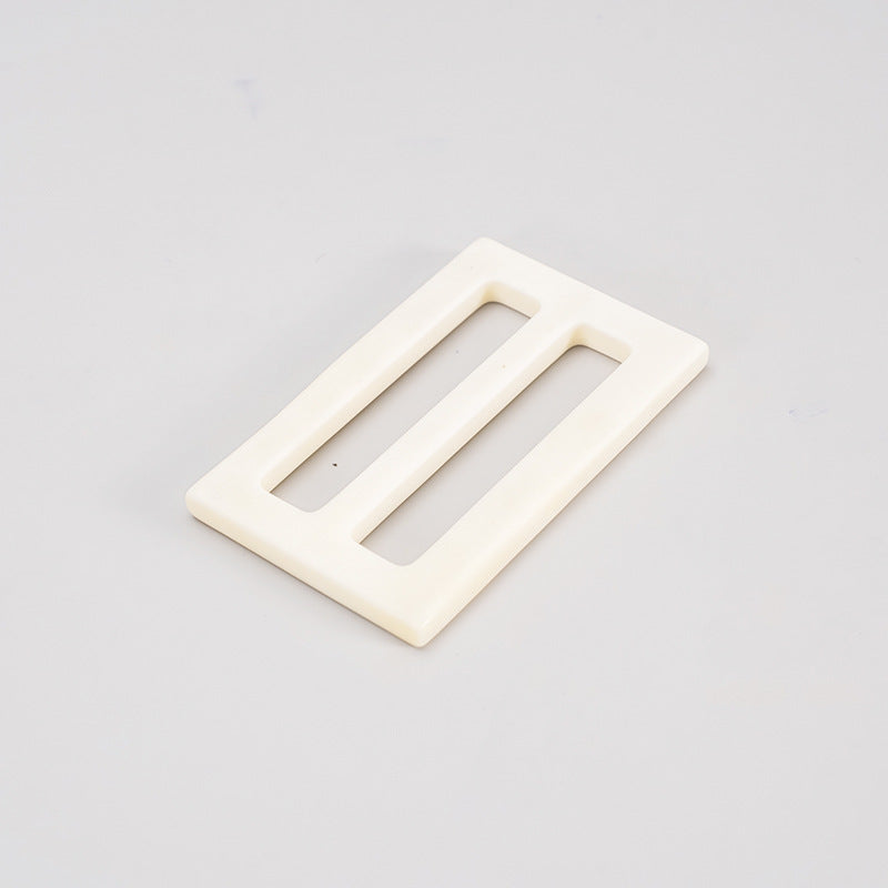 White bone belt adjuster buckle, rectangular frame with two open slots