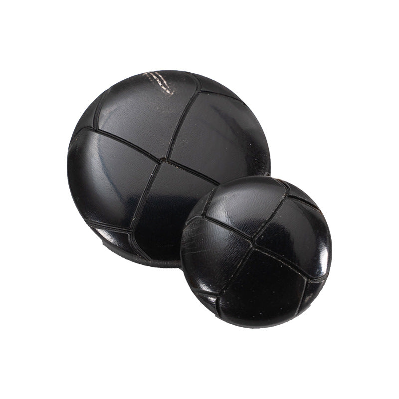 25mm black round vintage horn-style buttons, front view, panel seams