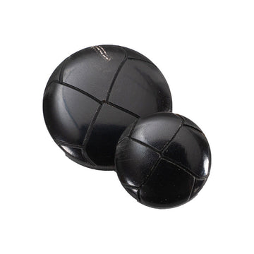 25mm black round vintage horn-style buttons, front view, panel seams
