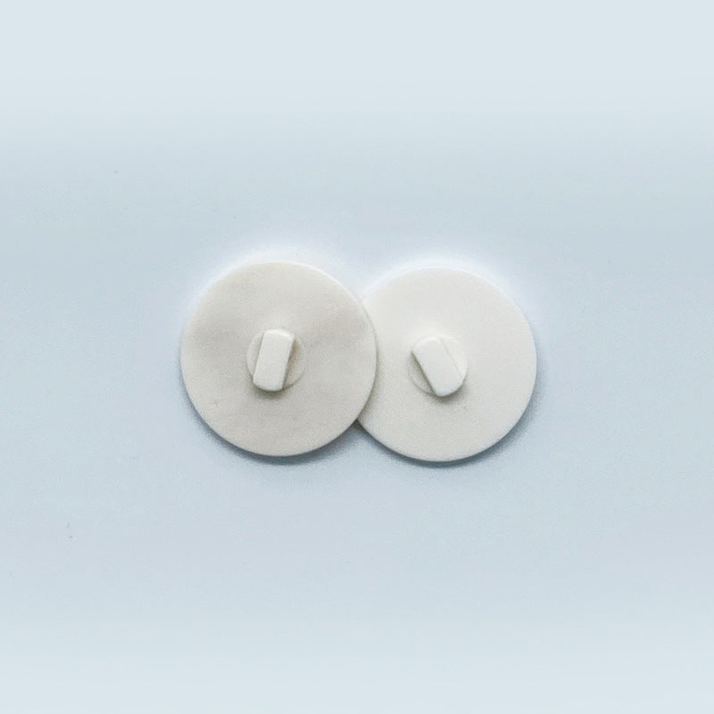 White round-edge bone buttons showing back shank stems (pair)