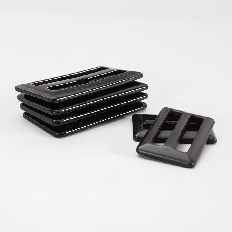 Set of 2 black horn coat belt adjuster buckles, one stacked and one separate