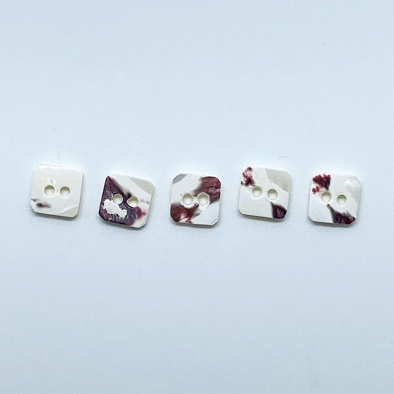 Set of square conch shell buttons with two holes; white base with purple marbling (5 shown)
