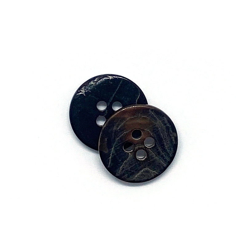 Close-up of two round 4-hole shell buttons, coffee-toned, front views