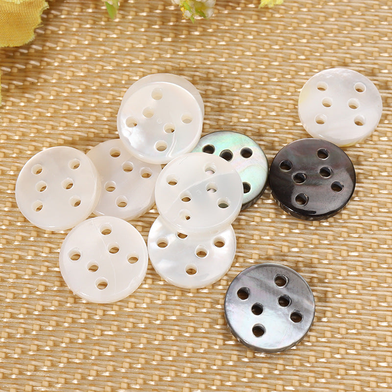 Assorted round six-hole shell buttons: white and dark/black with six holes each