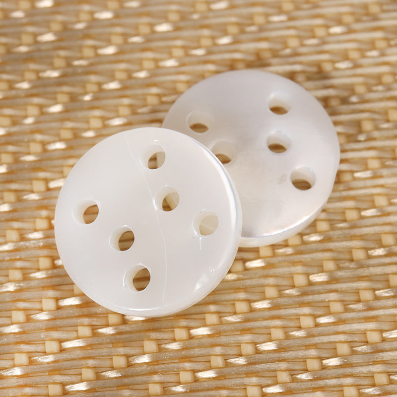 Round six-hole shell buttons in white, 2-piece view with six holes each