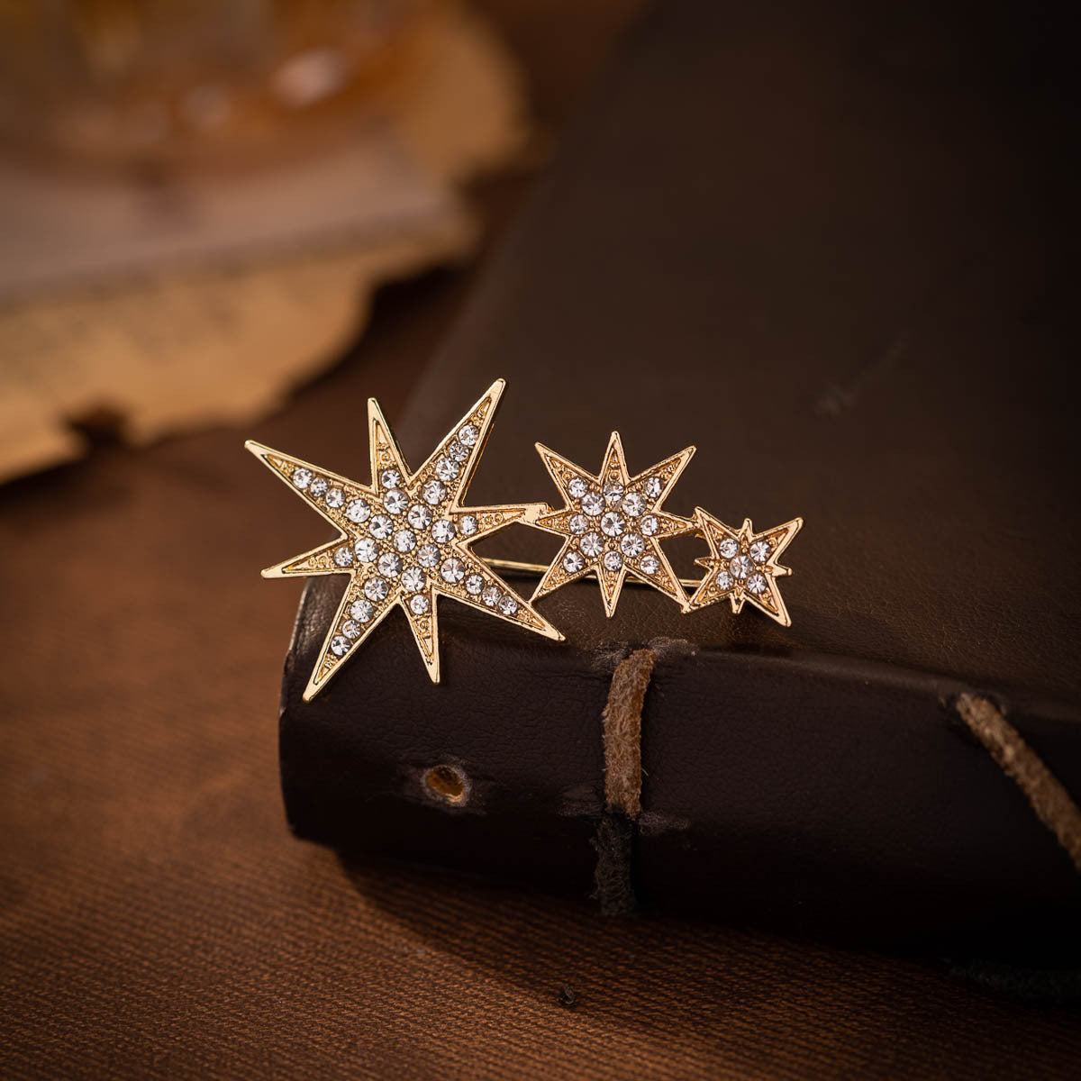 Gold eight-point star pin brooch pair, rhinestone starburst design