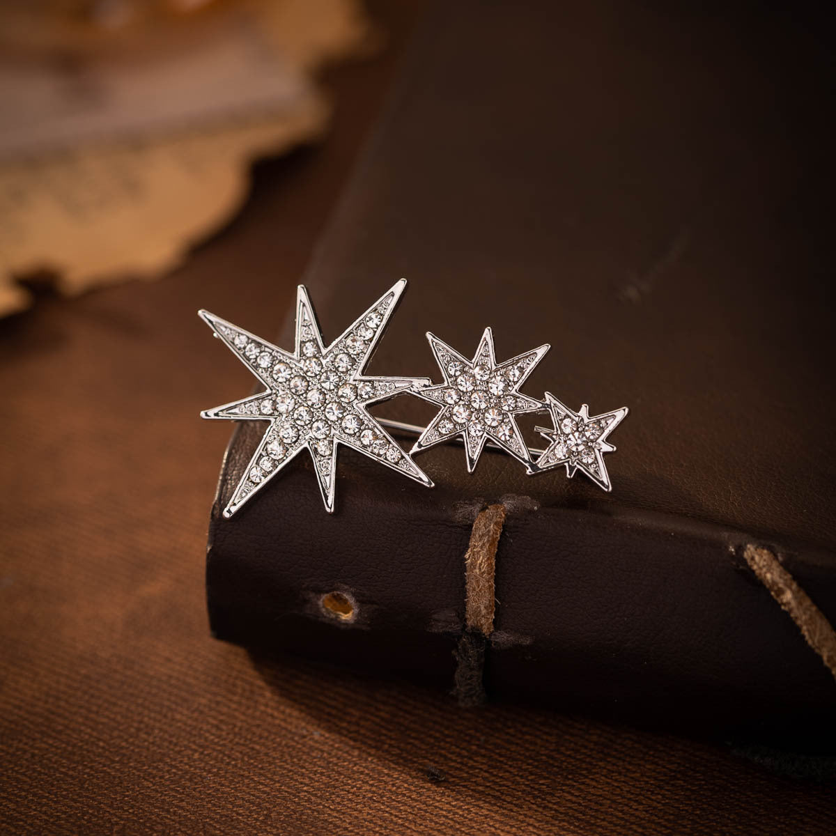 Silver eight-point star pin brooch pair, rhinestone starburst design