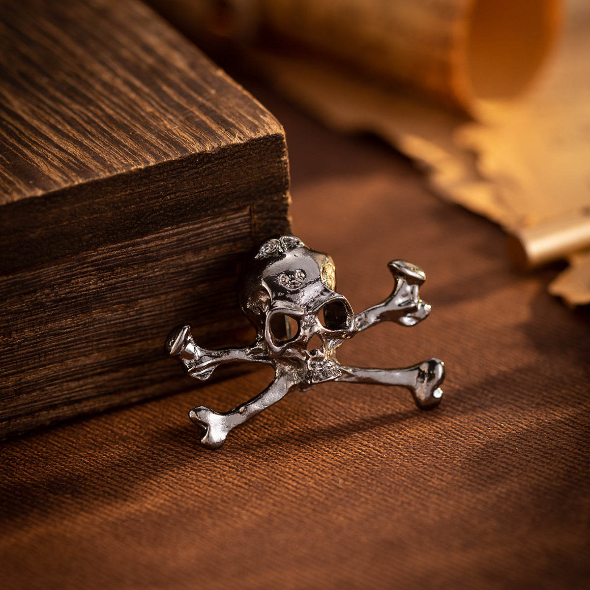 Gun black skull crossbones metal brooch pin, front view with open-work skull detail