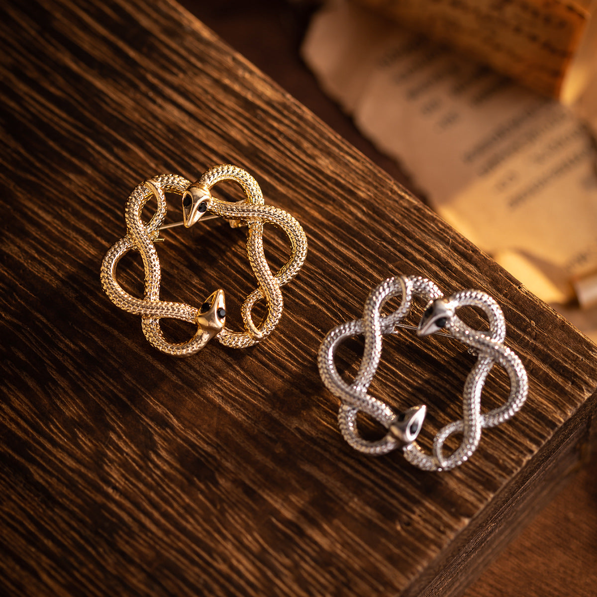 Gold retro flower-and-snake metal brooch, circular openwork with black eye accents