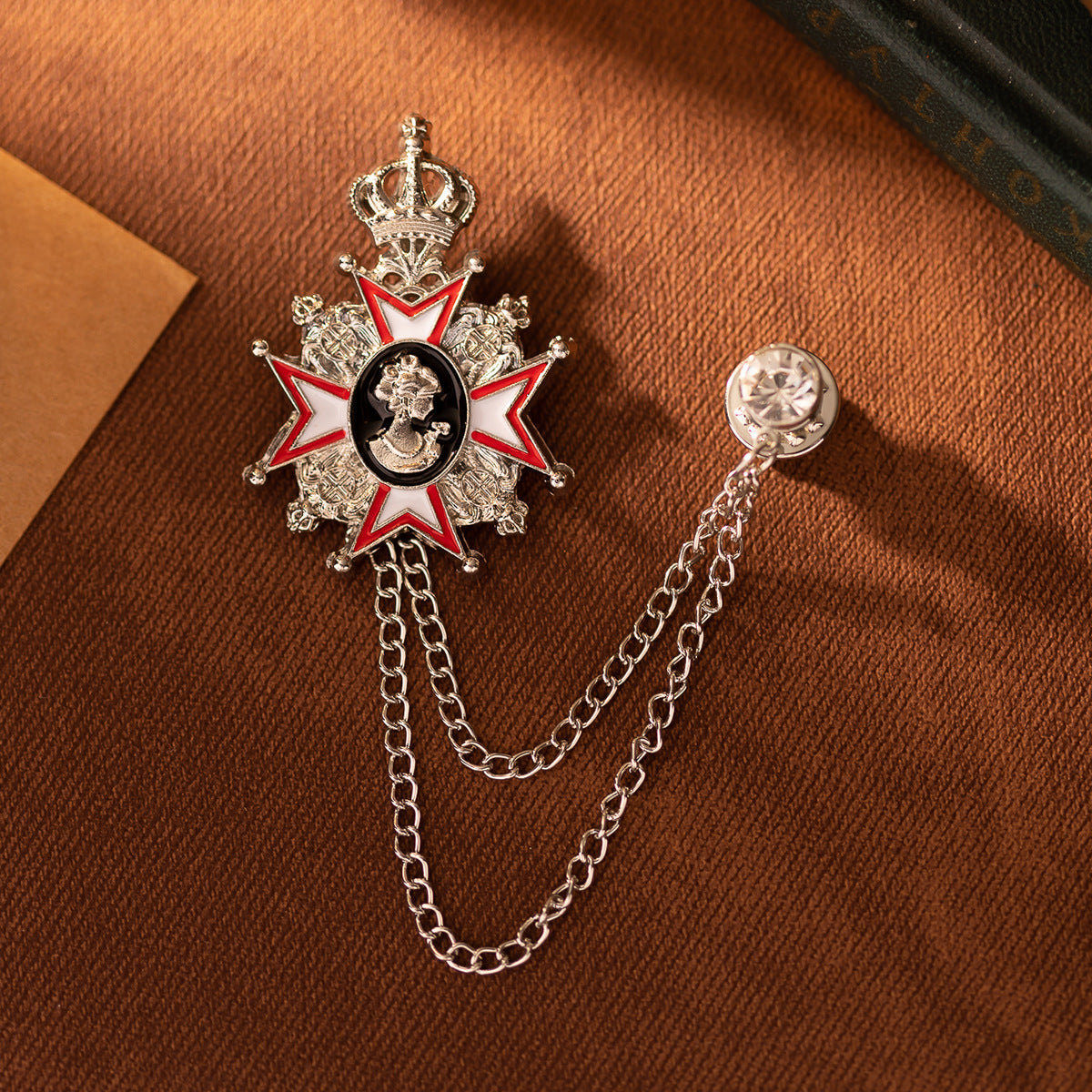 Brooch pin set with crown star medallion and clear-stone topper, linked chain design