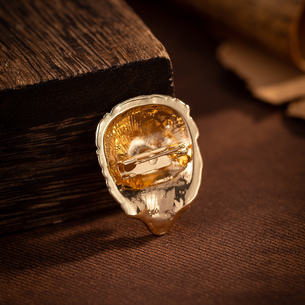 Lion head brooch back view with silver pin clasp and golden backplate