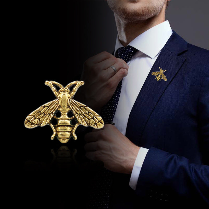 Gold-tone bee-shaped brooch pin on a suit lapel, decorative badge for men