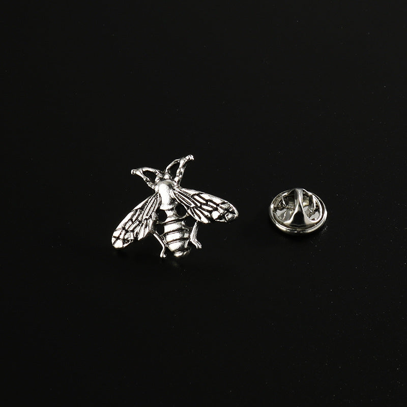 Silver-tone bee brooch pin, textured wings and striped body with round cutouts