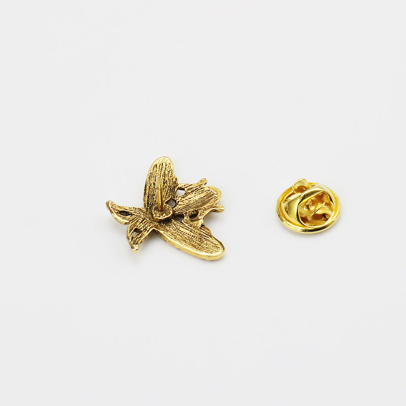 Gold-tone bee brooch front and round pin back, textured wings and striped body