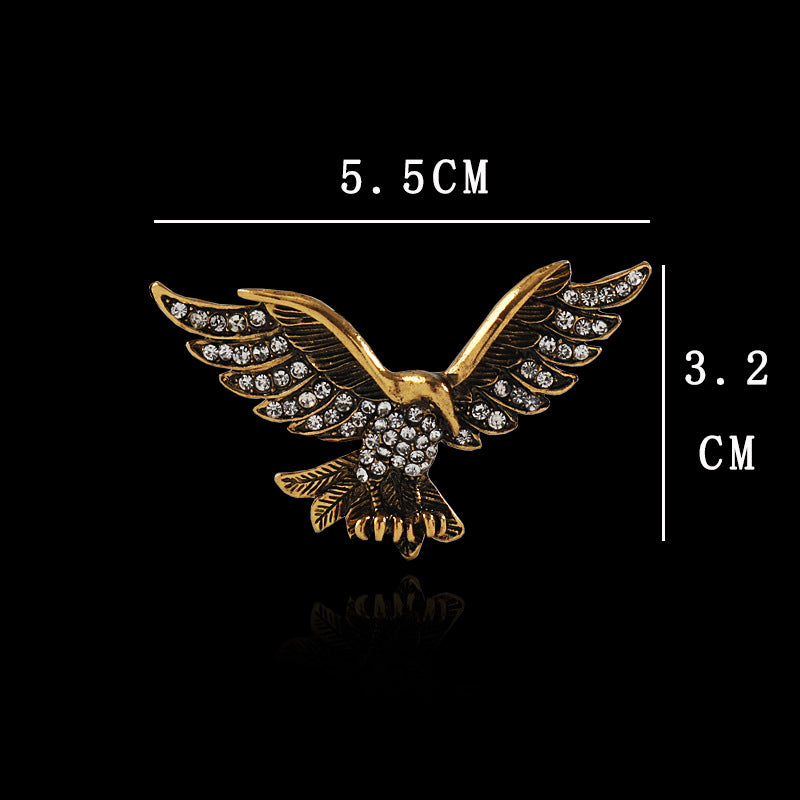 Gold-tone eagle wing brooch with rhinestones, size 5.5 cm by 3.2 cm