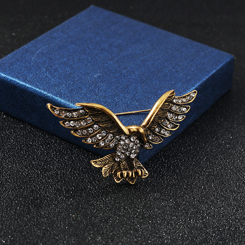 Gold-tone eagle wing brooch with rhinestone pattern