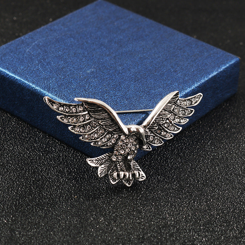 Silver-tone eagle wing brooch with rhinestone pattern
