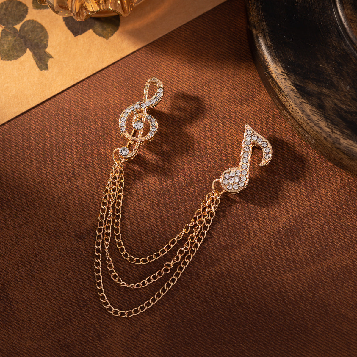 Gold-tone and silver-tone diamond music note brooch with tassel chain, two-pack