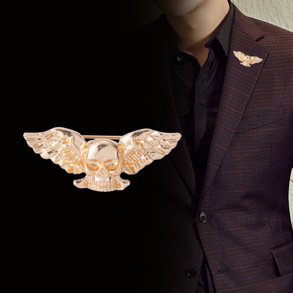 Gold winged skull brooch on jacket lapel