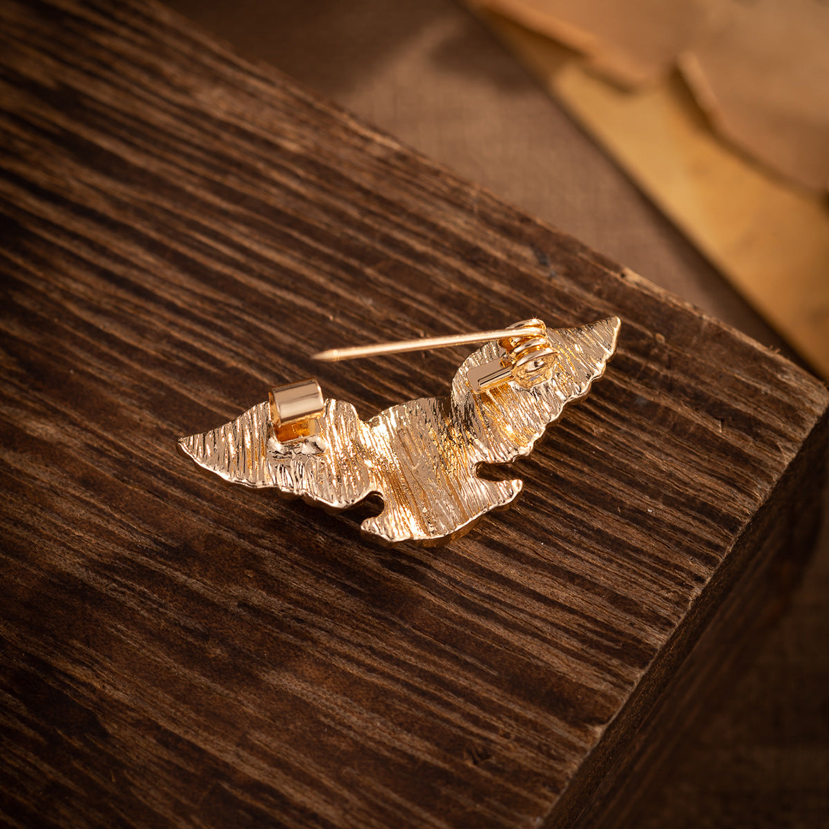 Gold winged skull brooch with pin and clasp