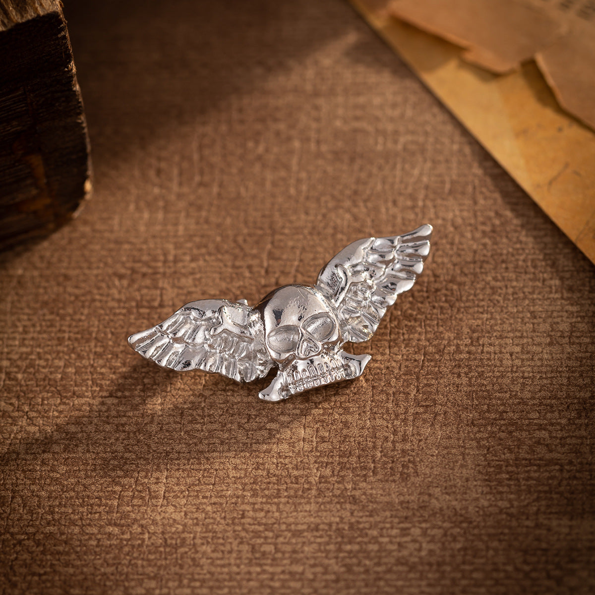 Silver winged skull brooch with hinged pin