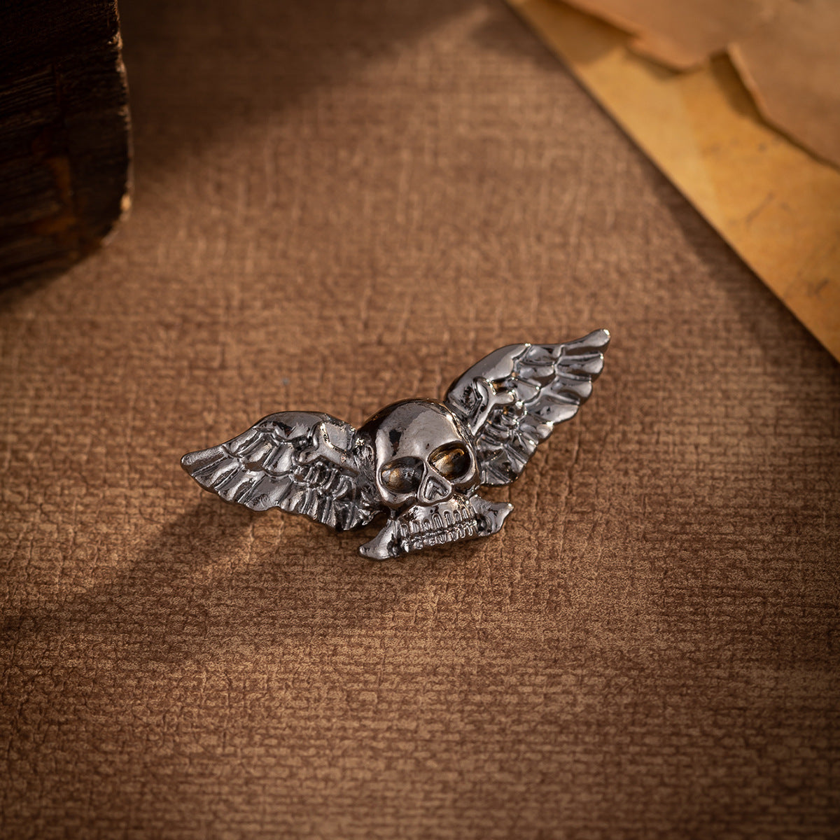 Gunmetal winged skull brooch with skull face detail
