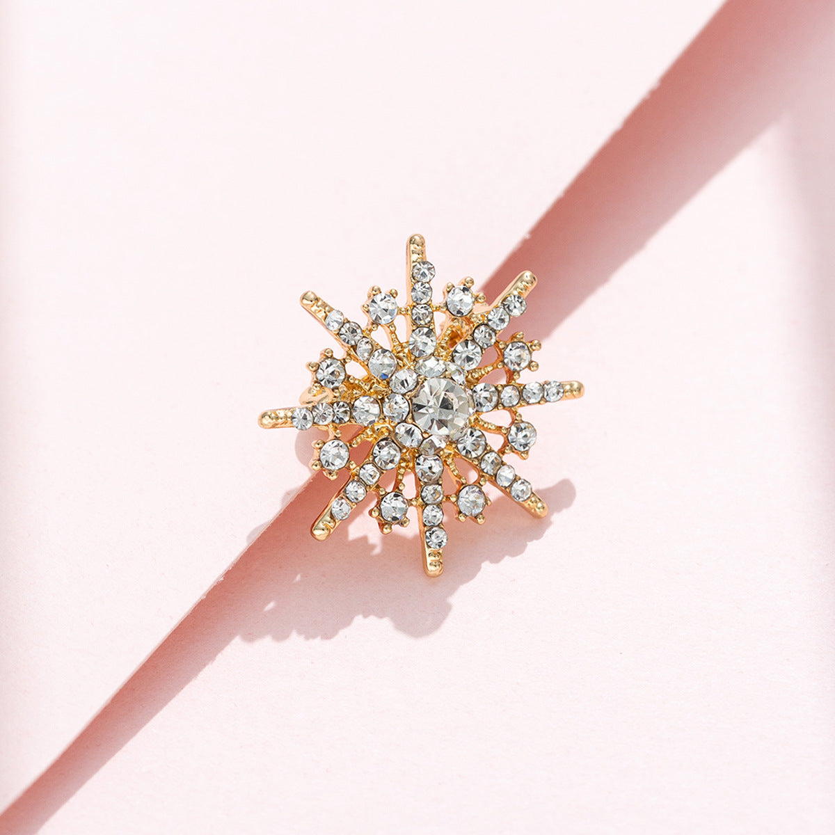 Eight-pointed star diamond brooch, gold-tone setting with sparkling clear crystal clusters.