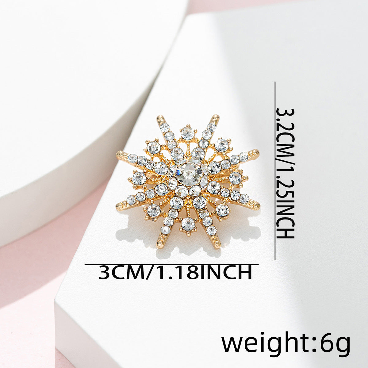 Eight-pointed star diamond brooch; approx. 3 cm length, 6 g weight, gold-tone crystals.