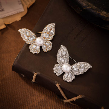 Diamond butterfly brooch with faux pearl center, silver-tone pave stones