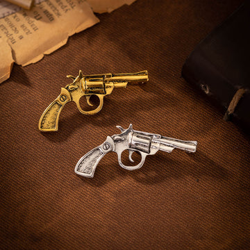 Retro revolver brooch pair: gold and silver-tone pistol designs with clasp