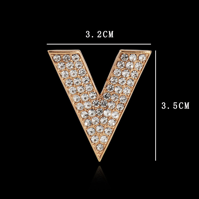 Gold V-shaped rhinestone brooch, pointed triangle design, size marked 3.5 cm