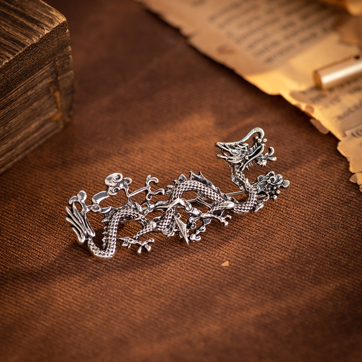 Silver Chinese dragon totem brooch with textured scales and pin back