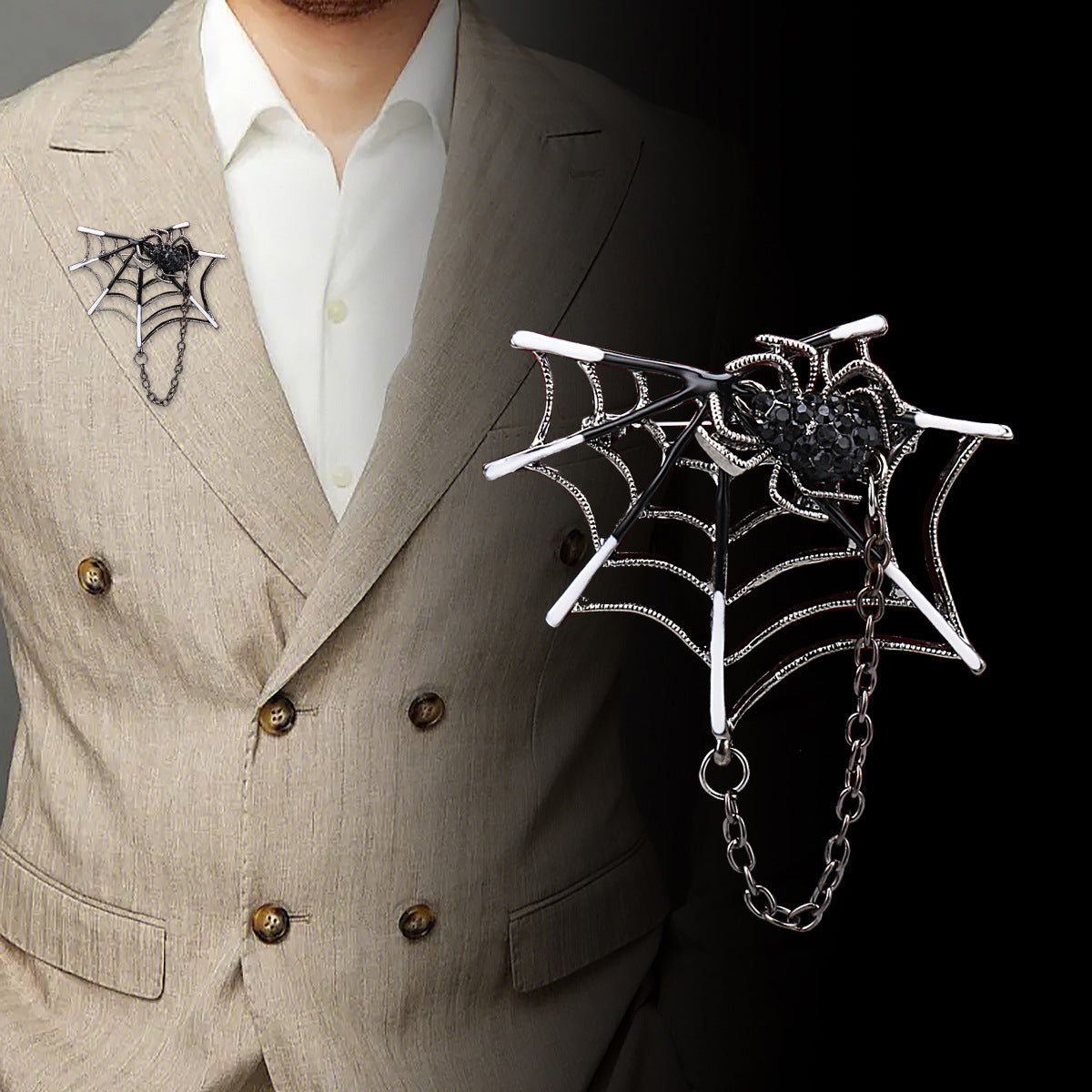Silver spider-web brooch with black rhinestone spider detail and dangling chain