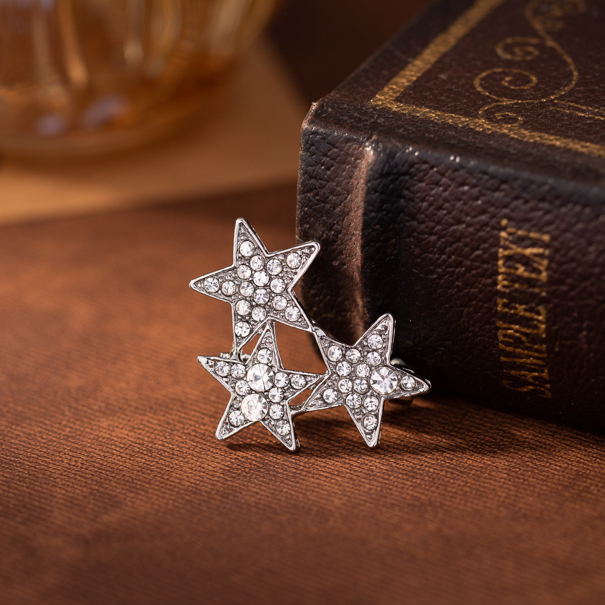 Silver-tone three star diamond lapel pin set with rhinestone sparkle points