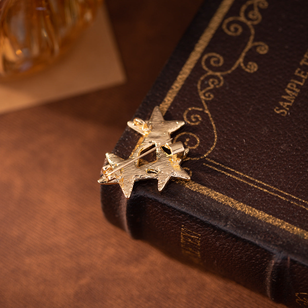 Gold-tone five-point star lapel pin back with clasp, part of 3-piece set