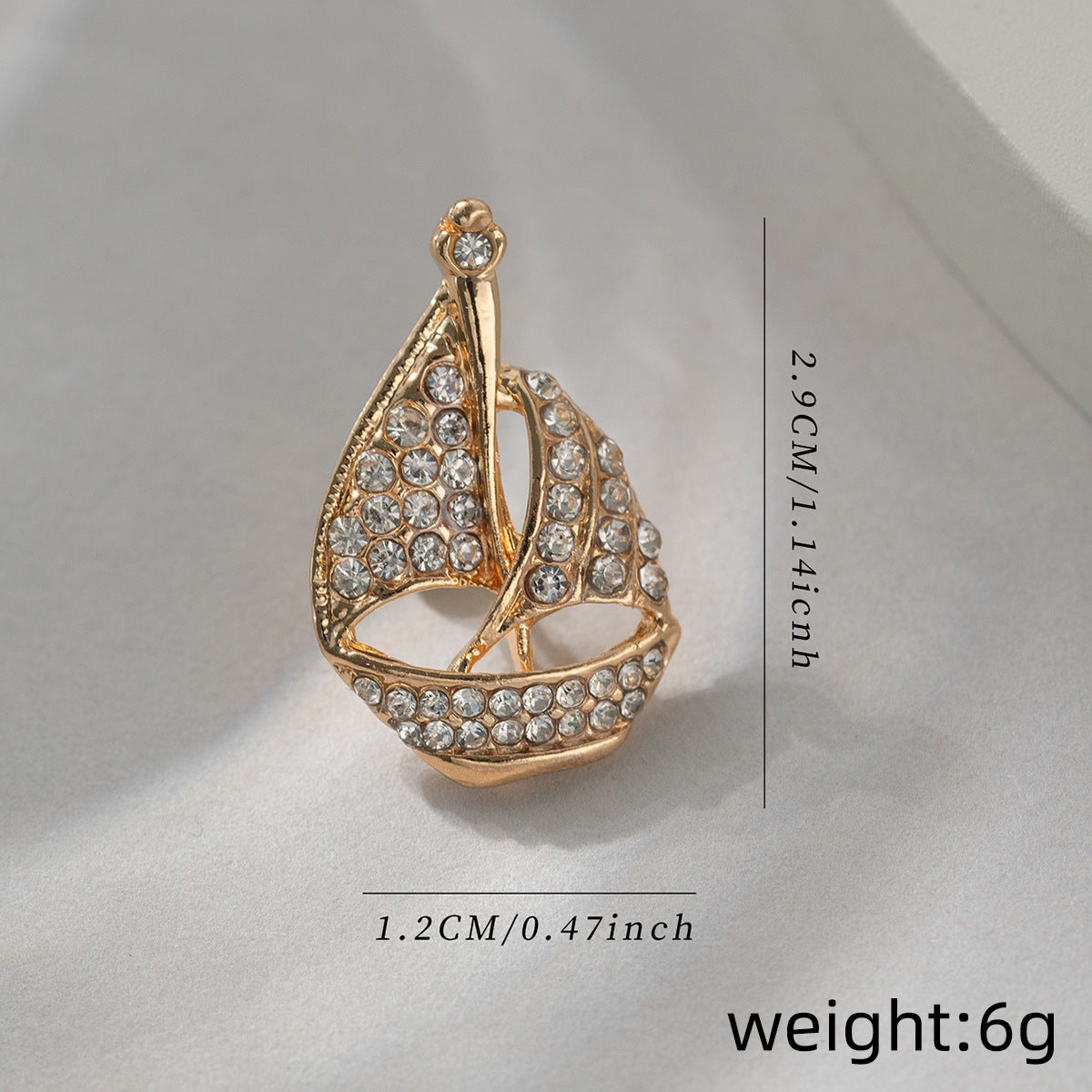 Gold-tone sailboat brooch pin, 2.9cm length; weight 6g; crystal diamond detail