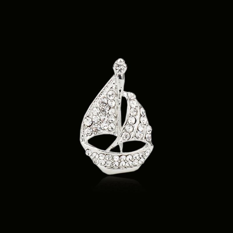 Silver-tone diamond sailboat brooch pin with faceted crystal pattern