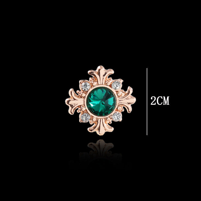 Green cross lapel pin with clear accents, rose-gold tone, 2 cm size